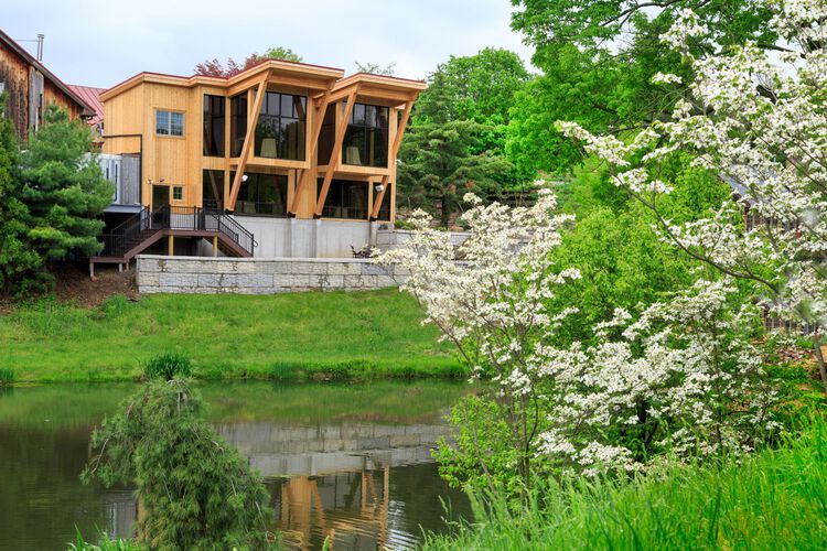 Building next to pond and trees